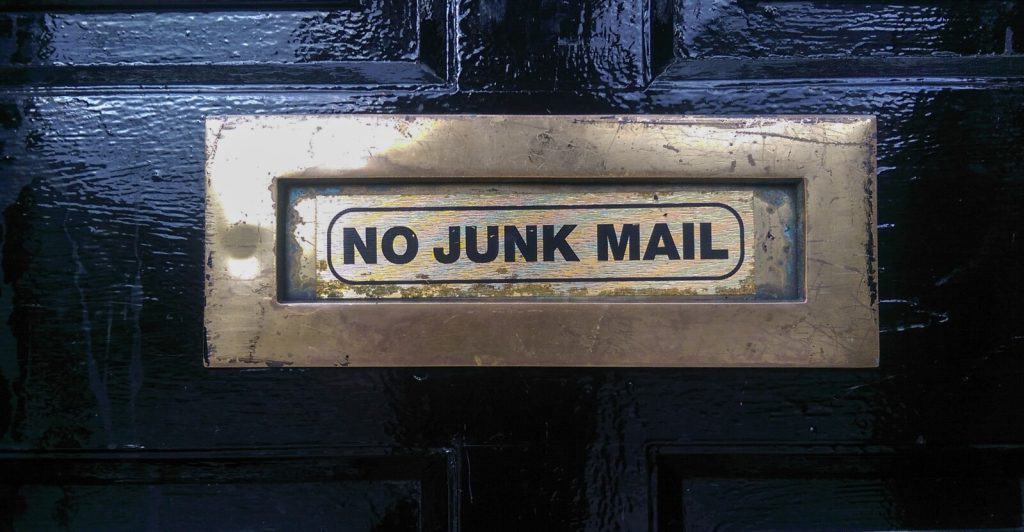 No junk mail sign on a black door.