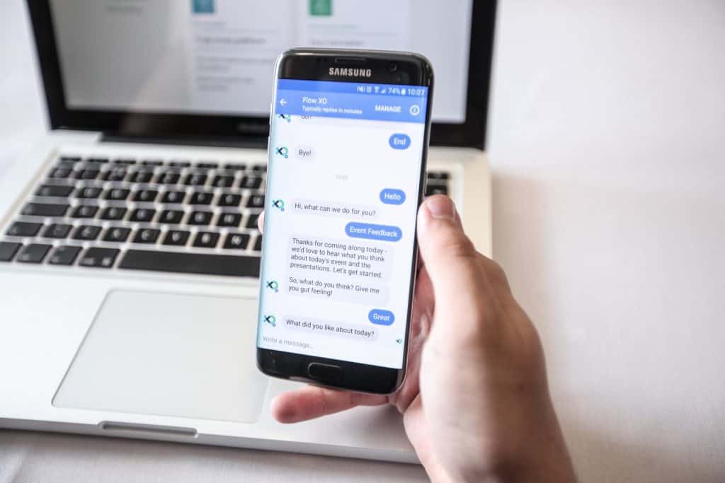 A person holding a smartphone with a text message on it.