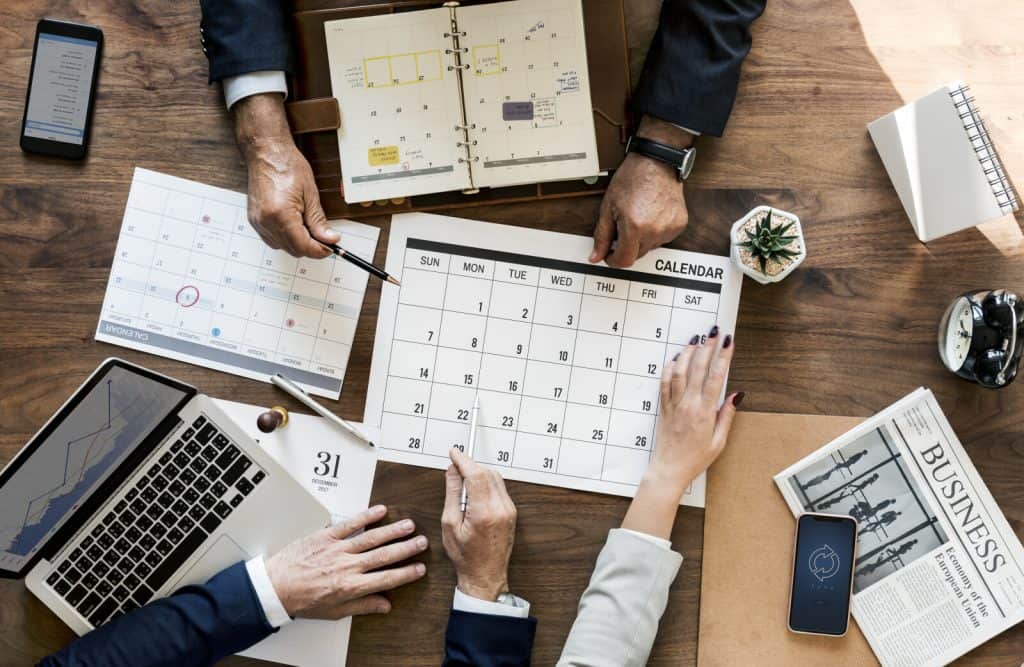 A group of business people working on a calendar.