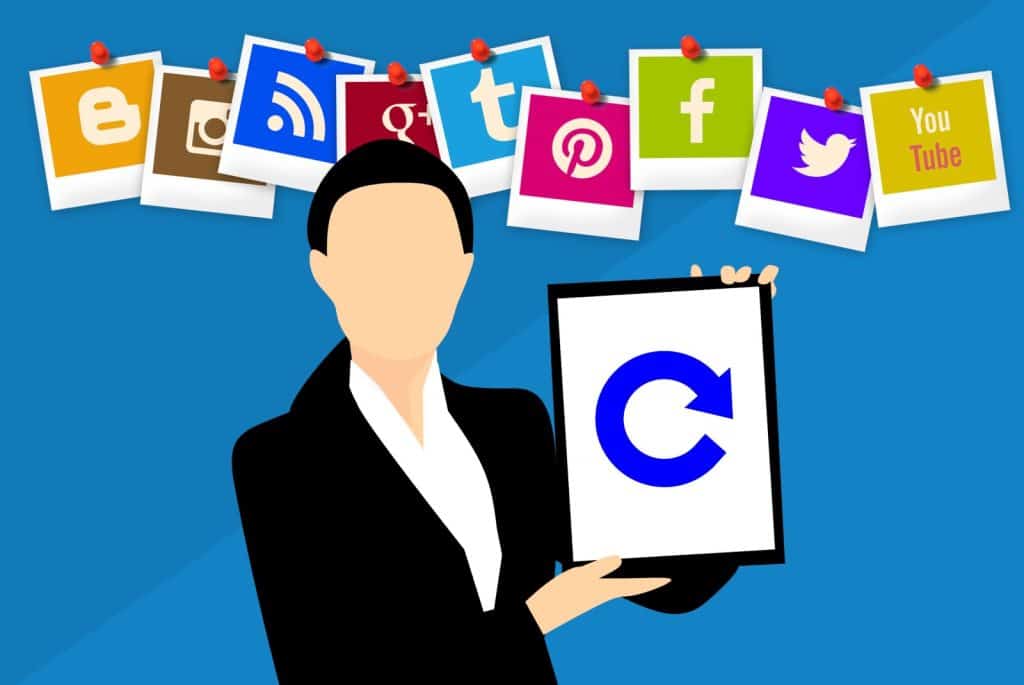 A woman holding up a tablet with social icons on it.