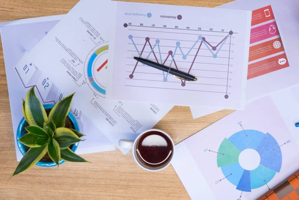 A desk with papers and graphs on it.