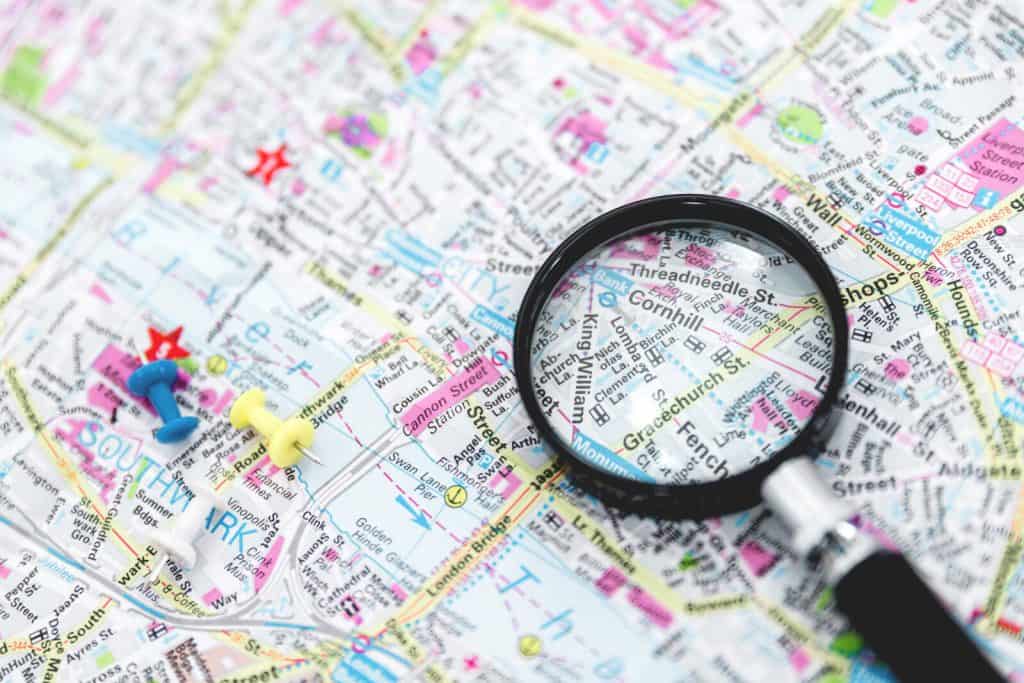 A magnifying glass is placed on top of a map.